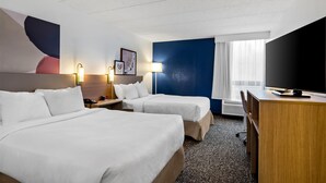 A hotel room with two beds, a desk, a TV, and a large window with curtains. - Spark by Hilton Wytheville Holston Rd I 81 (Wytheville)