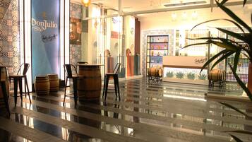 Welcome to our lobby, featuring a polished floor, comfortable seating, and a reception desk with a unique display.