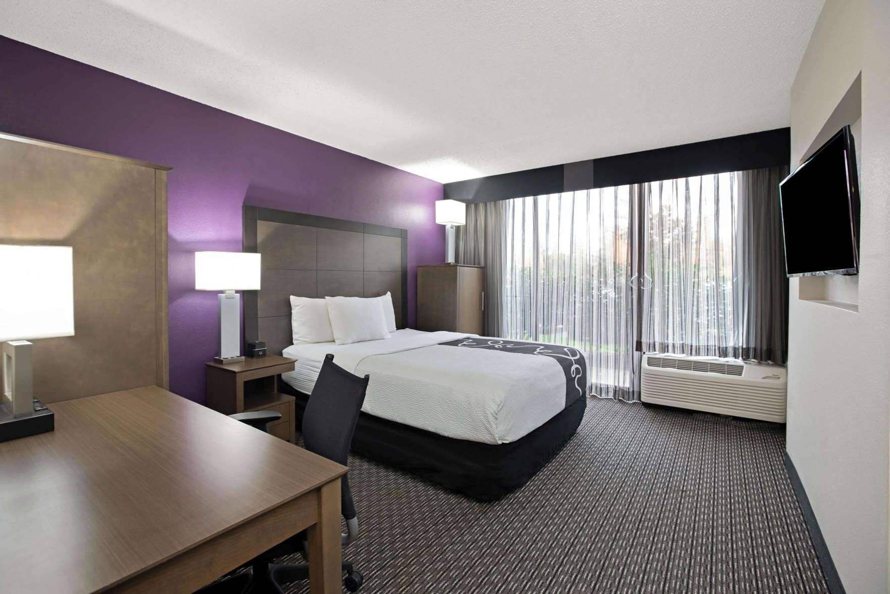 Premium bedding, desk, laptop workspace, blackout curtains