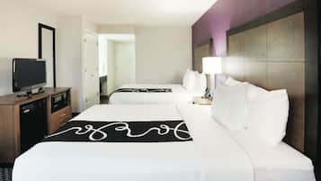 Premium bedding, desk, laptop workspace, blackout drapes