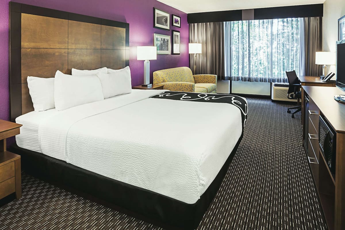 Premium bedding, desk, laptop workspace, blackout drapes