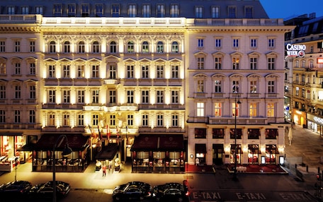 A multi-story hotel with a classic European architectural style, featuring ornate facades and large windows.