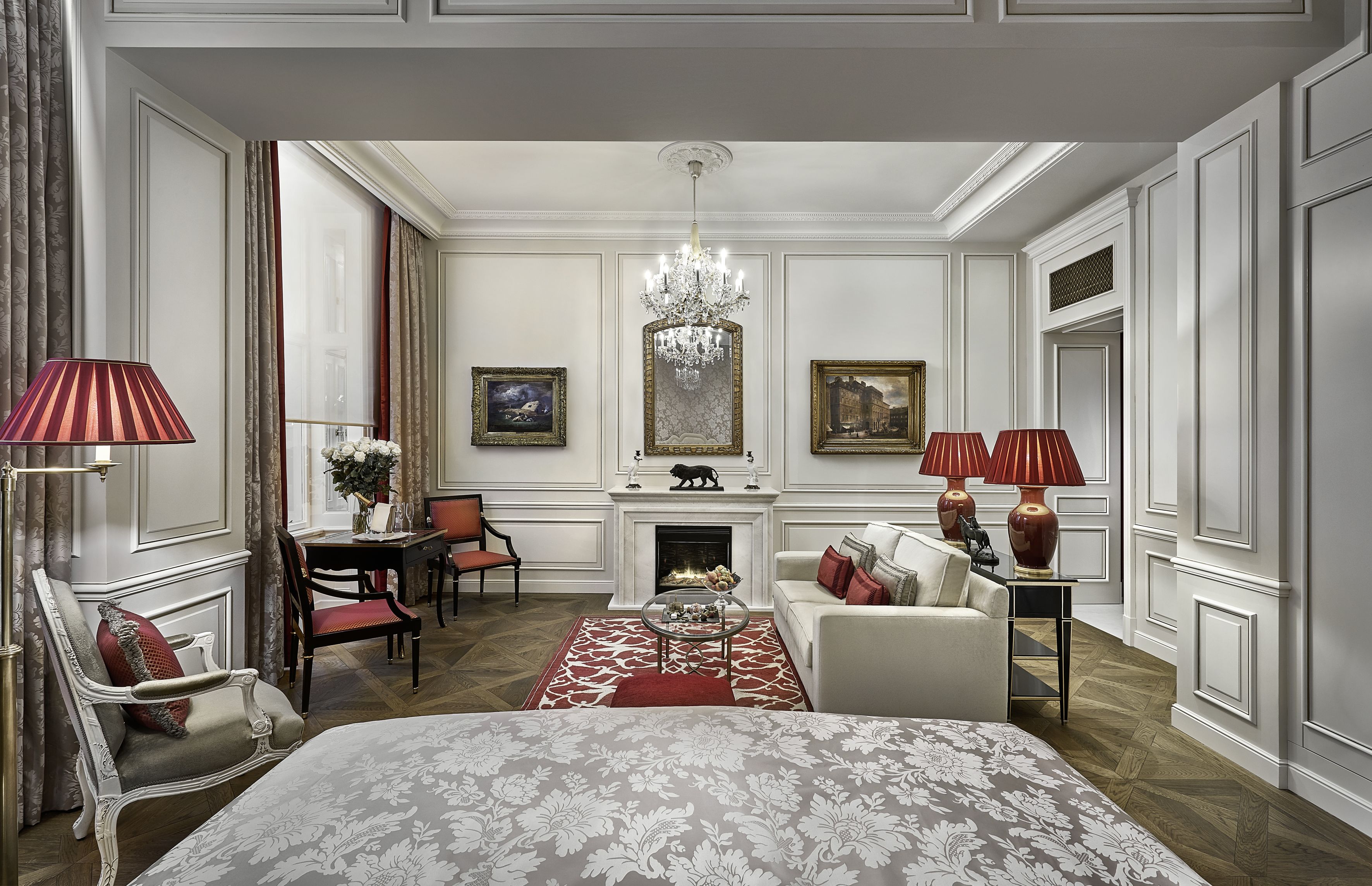 A classic room with a fireplace, elegant furniture, and a chandelier.