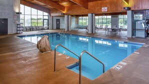 An indoor swimming pool with clear lanes, a lifeguard station, and a view of the outdoors through large windows. - DoubleTree by Hilton Appleton (Appleton)