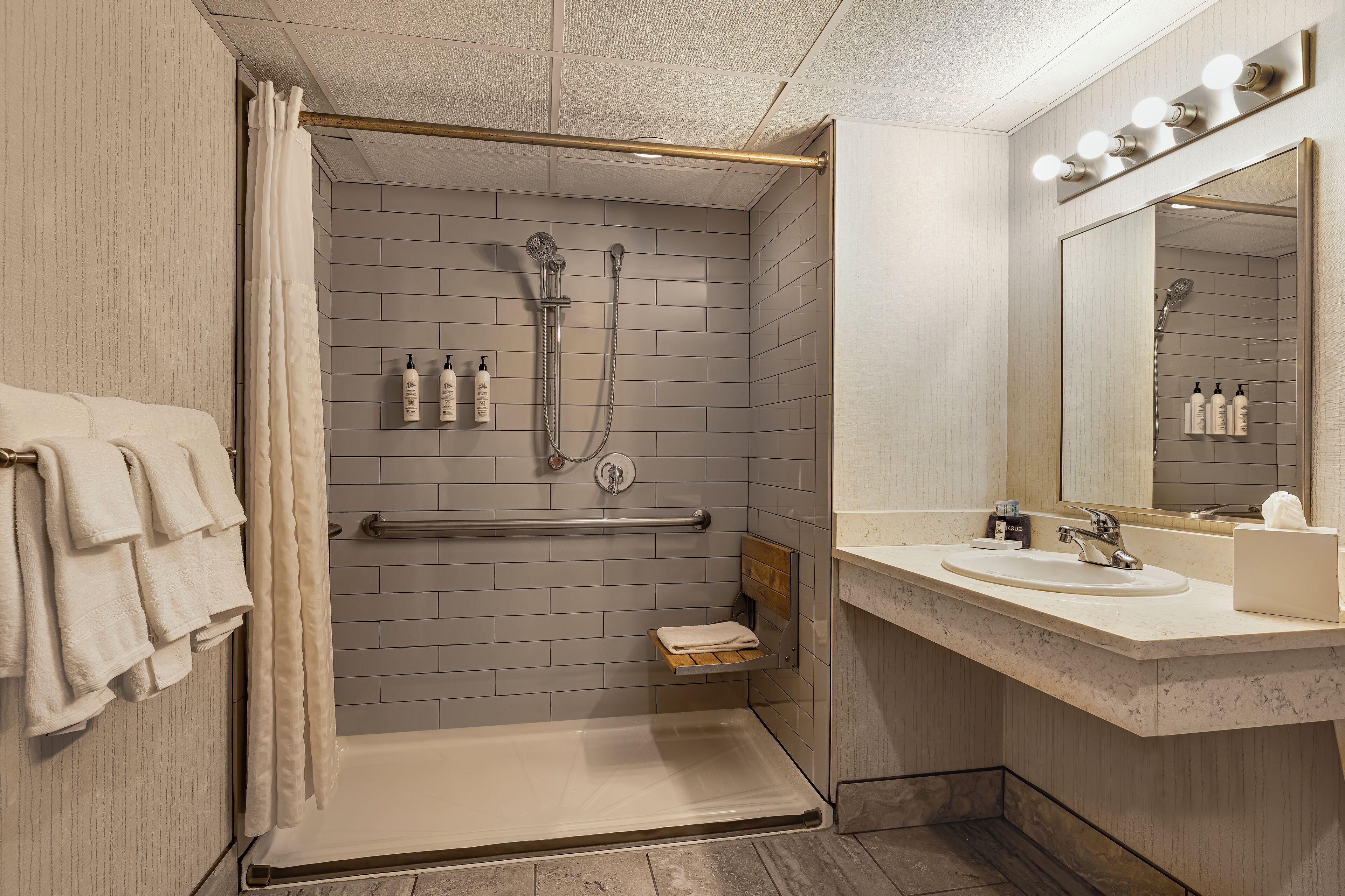 combined shower/bathtub, designer toiletries, hair dryer, towels