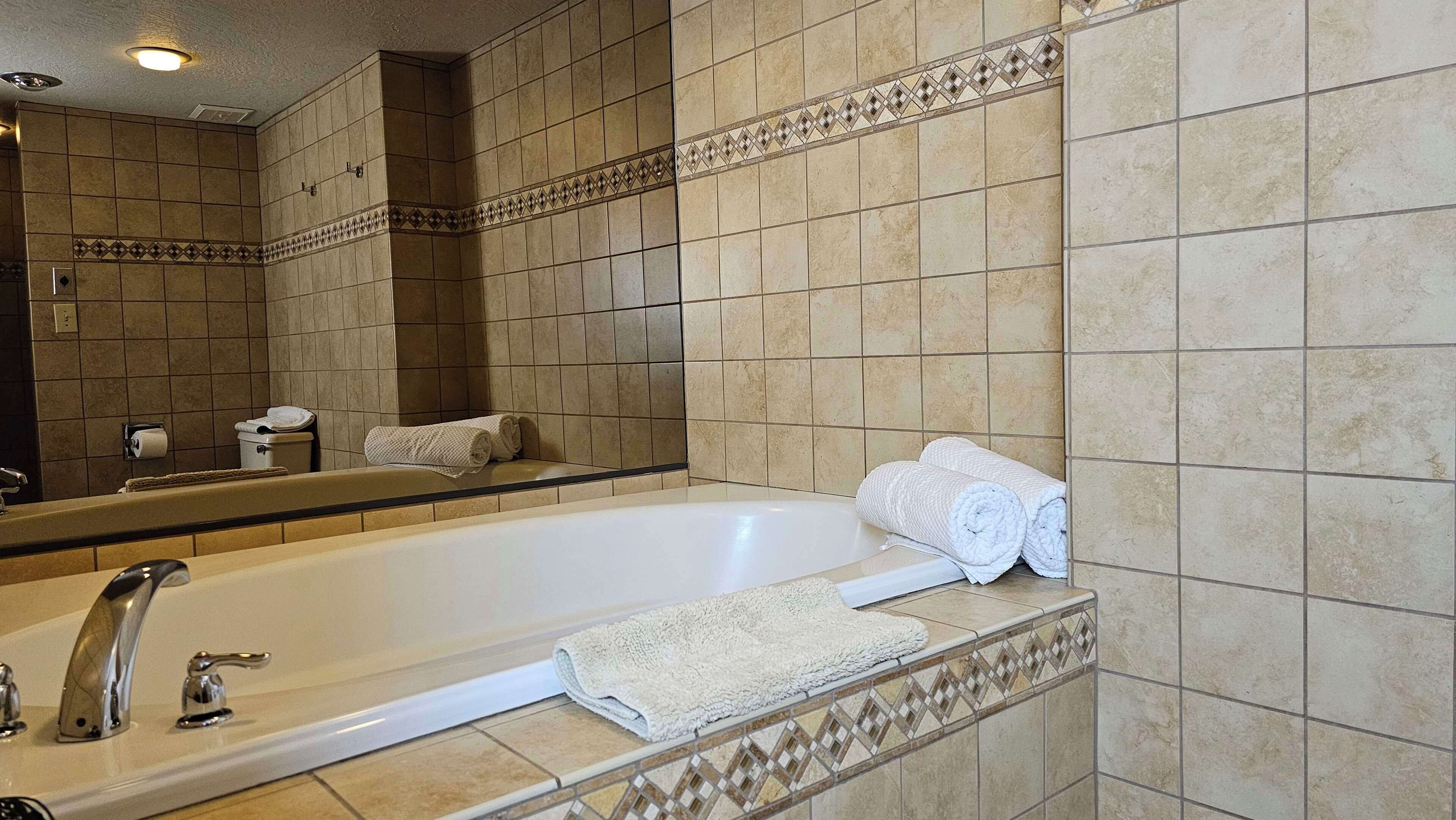 suite, 1 king bed, non smoking, jetted tub | bathroom | combined shower/bathtub, free toiletries, hair dryer, towels