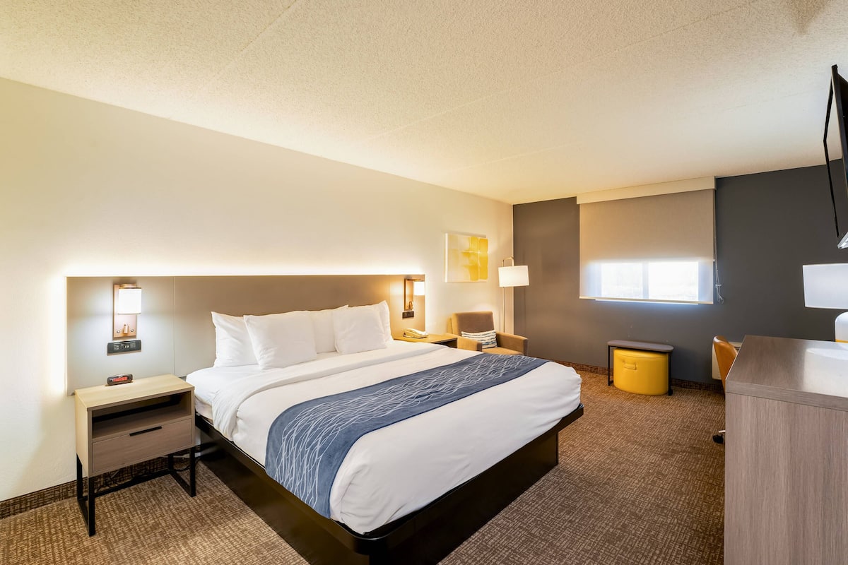 Relax in this inviting space with a comfortable bed, a desk for work, and a cozy chair.