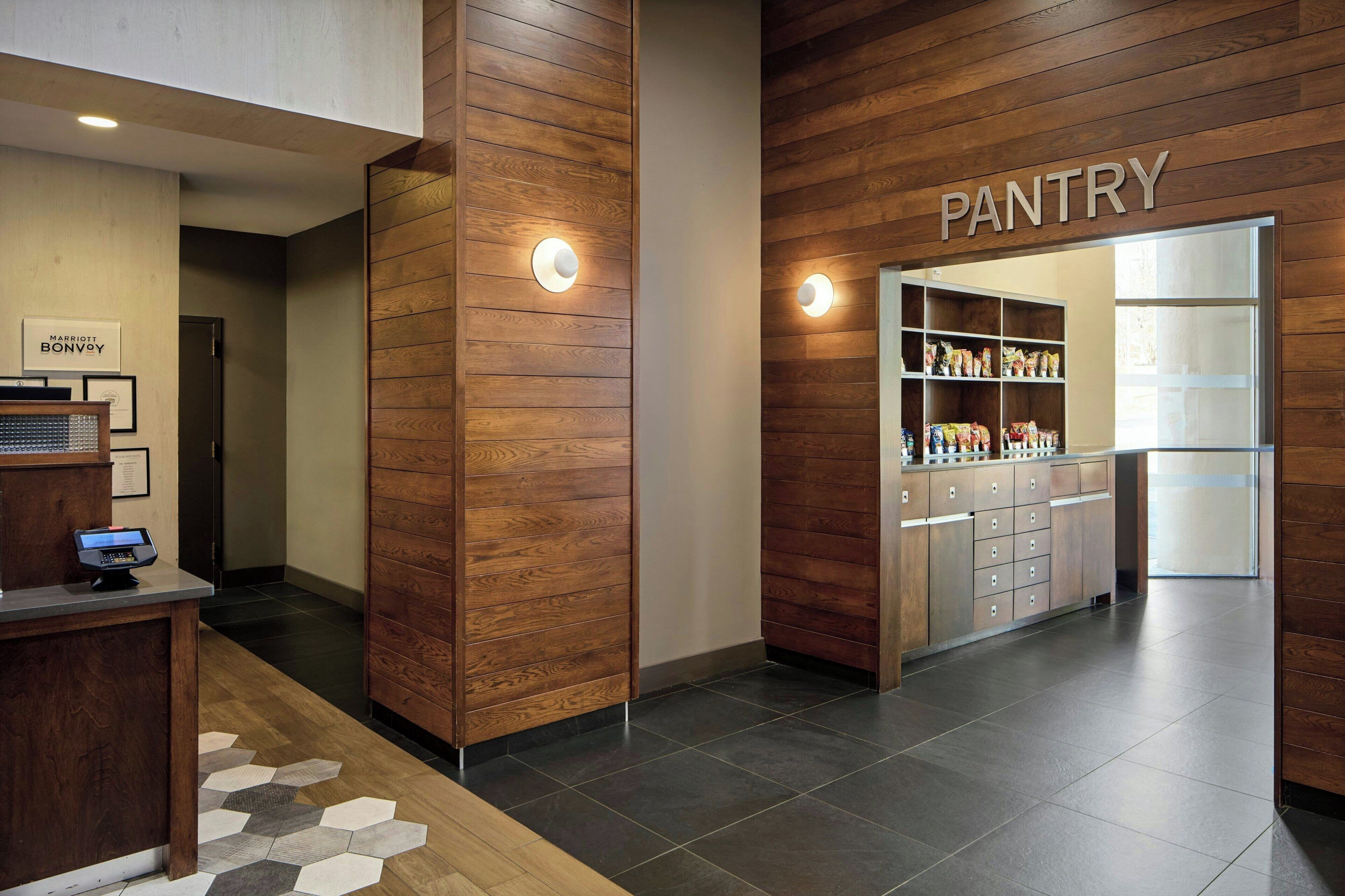 A hotel pantry with wooden paneling and a modern design.