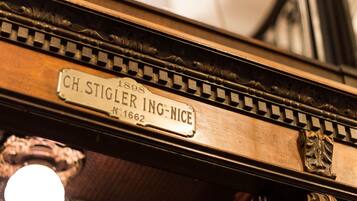 A close-up of a piano with a label reading "CH. STIGLER ING-NICE No. 1662 1898".