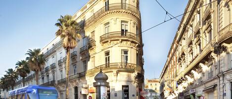 A curved building with a classical architectural style, featuring balconies and ornate details.