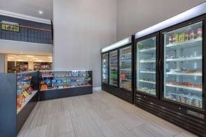 A clean, well-lit indoor space with a snack bar, refrigerated display cases, and a staircase leading to an upper level. - Clarion Hotel Conference Center Lexington North (Lexington)