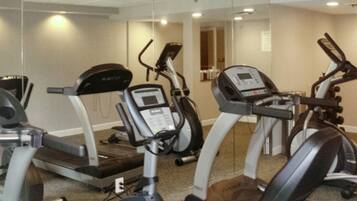 A fitness center with treadmills, elliptical machines, and a stationary bike.