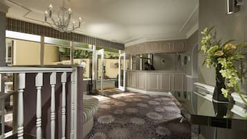 A spacious kitchen with modern appliances, a dining area with a chandelier, and a view of the outdoors.
