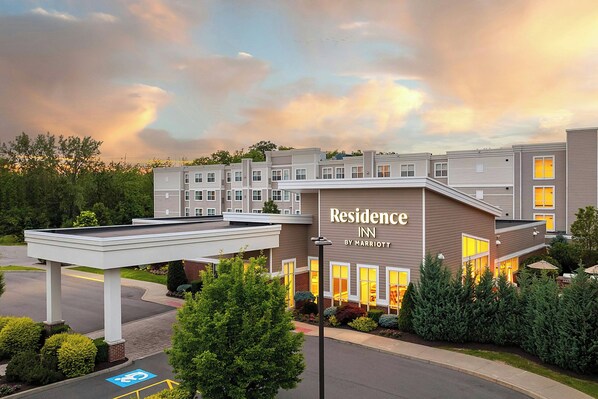 A multi-story hotel building with a sign reading 'Residence Inn by Marriott'.