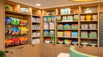 A well-organized pantry with various food items and kitchenware.