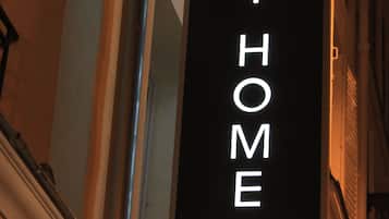 A vertical sign with the text "MH HOTEL MY HOME IN PARIS" against a dark background.