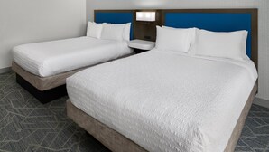 A hotel room with two beds, a nightstand, and a wall-mounted lamp. - Hampton Inn & Suites Syracuse North Airport Area (Liverpool)