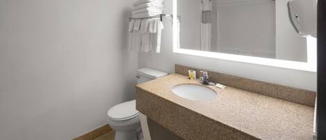 A bathroom with a toilet, sink, and towel rack.