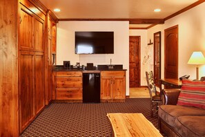 Premium Suite, 1 Bedroom | Living room | 50-inch flat-screen TV with cable channels