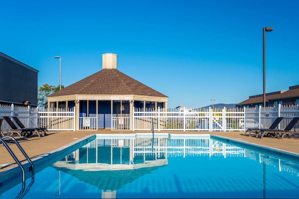 Seasonal outdoor pool, open 9:00 AM to 9:00 PM, pool umbrellas