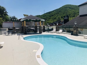 Seasonal outdoor pool, open 10:00 AM to 9:00 PM, pool umbrellas