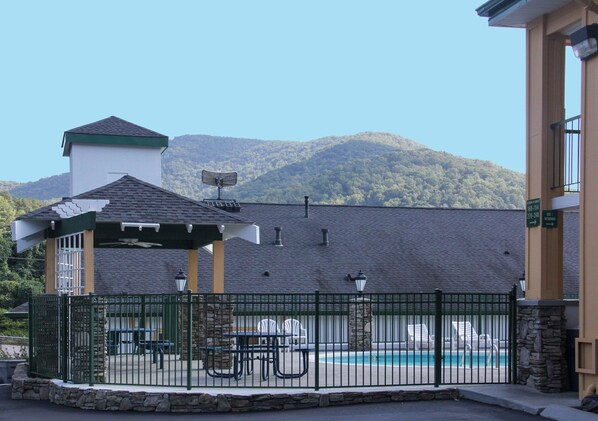 Piscine extérieure en saison, parasols, chaises longues