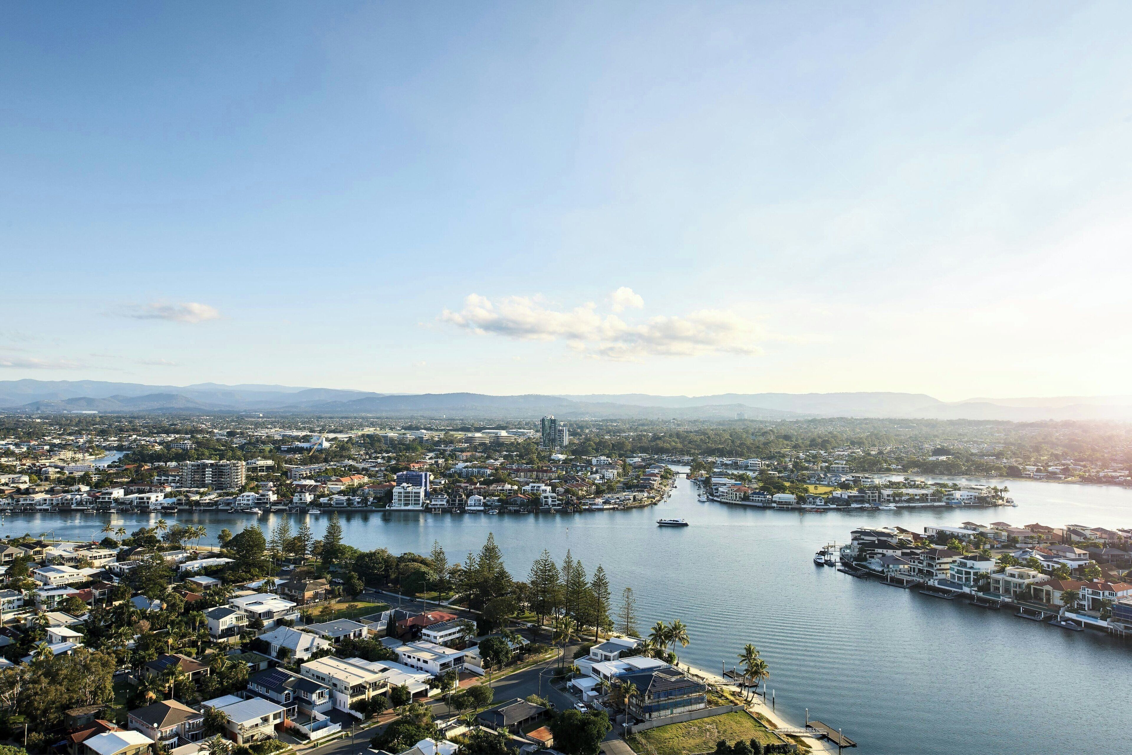 A coastal town with residential buildings, a marina, and a river.