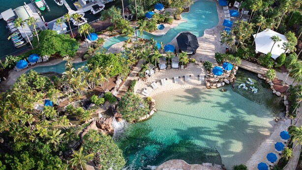 A resort with multiple swimming pools, lounge areas, and a dock with boats. - JW Marriott Gold Coast Resort & Spa (Surfers Paradise)