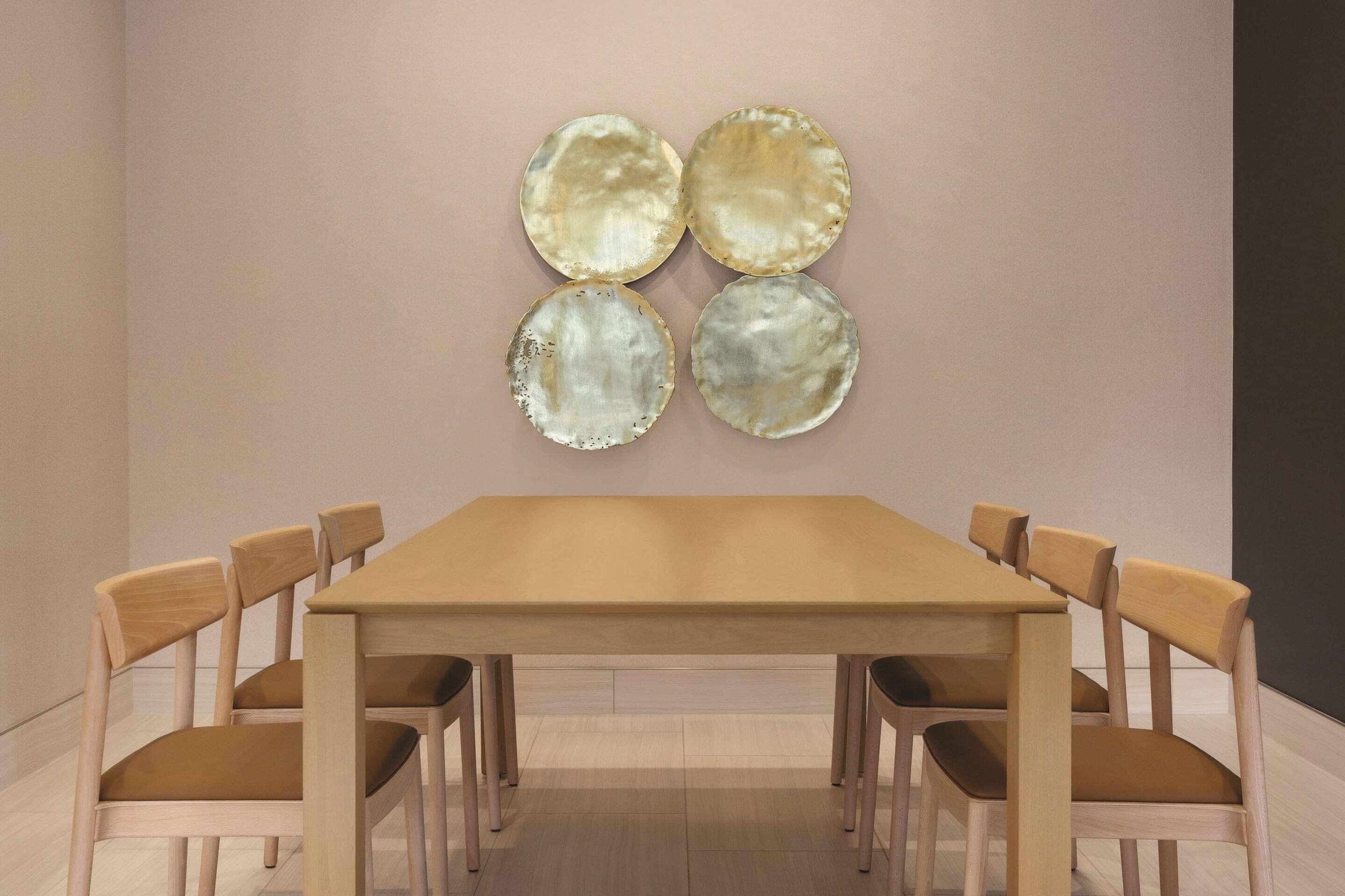 A dining area with a rectangular table and six wooden chairs.