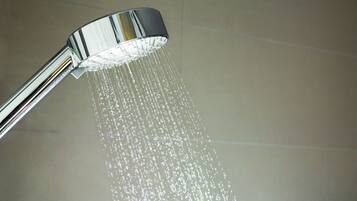 A showerhead with water flowing from it.