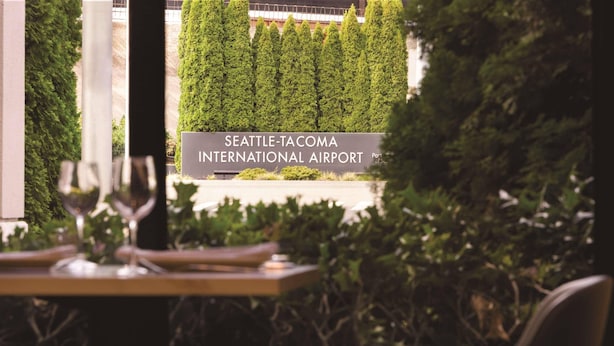 A view of Seattle-Tacoma International Airport with a sign in the foreground. - Radisson Hotel Seattle Airport (SeaTac)