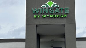 A building with a sign that reads "Wingate by Wyndham" and a logo above the text. - Wingate by Wyndham Dayton North (Dayton)