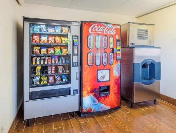 A vending machine with snacks and a Coca-Cola machine.