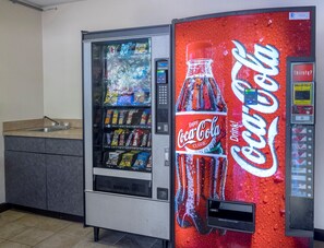 A vending machine with a Coca-Cola logo and a water dispenser. - Red Roof Inn Jacksonville - Orange Park (Jacksonville)