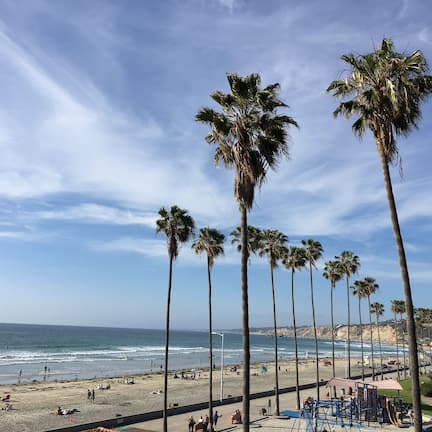 On the beach, white sand, sun loungers, beach towels