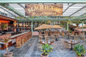 Een restaurant genaamd 'Beach House Baja Californian' met terras, een bar en een serre.