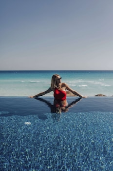 On the beach, white sand, beach cabanas, sun loungers at Kempinski Hotel Cancun