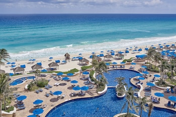 On the beach, white sand, beach cabanas, sun loungers at Kempinski Hotel Cancun