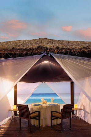On the beach, white sand, beach cabanas, sun loungers