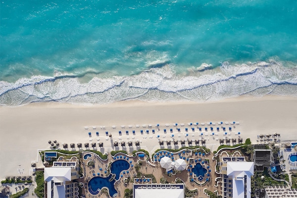 On the beach, white sand, beach cabanas, sun loungers