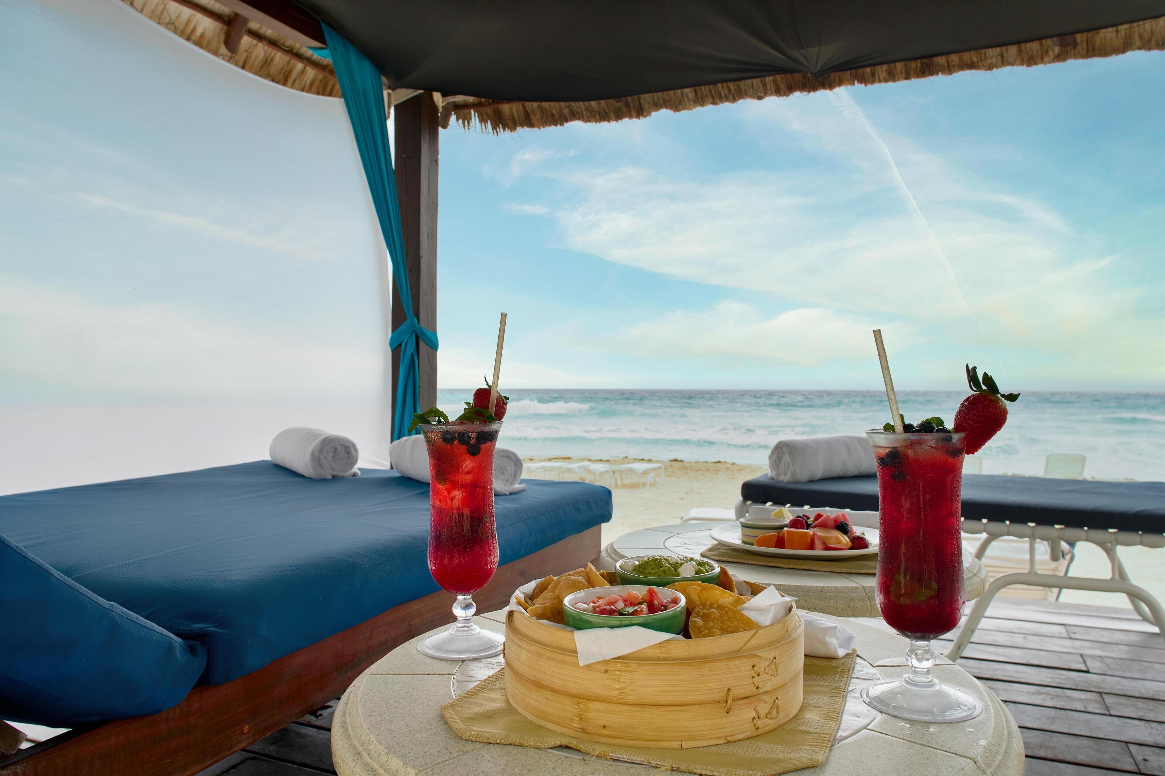 On the beach, white sand, beach cabanas, sun loungers