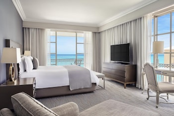 A large resort hotel with multiple balconies, a beachside location, and a view of the ocean. at Kempinski Hotel Cancun