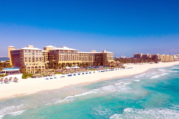 On the beach, white sand, beach cabanas, sun loungers