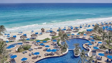 On the beach, white sand, beach cabanas, sun-loungers