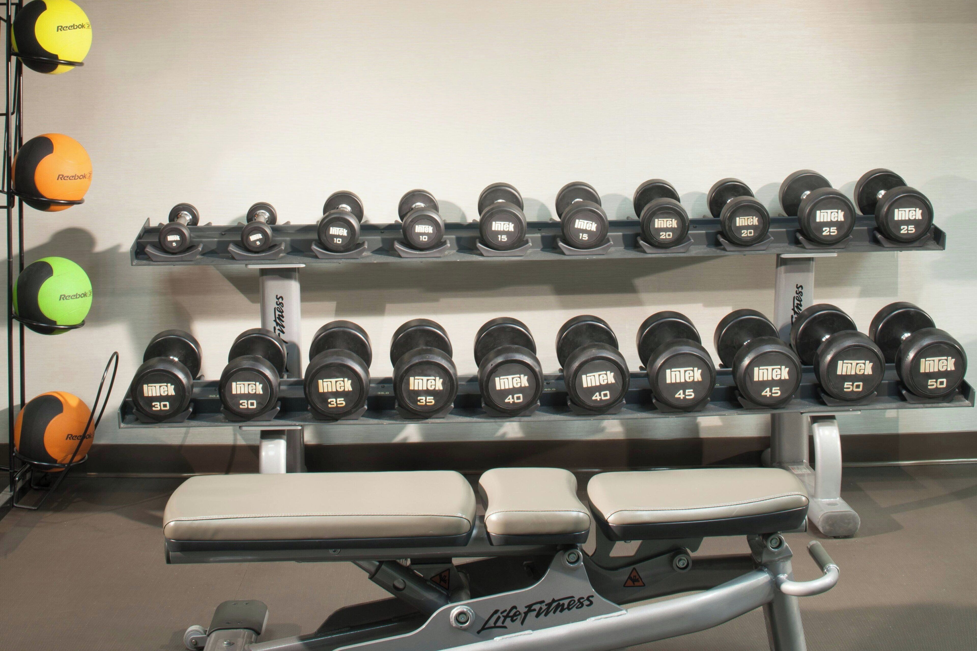 A gym with dumbbells and exercise balls.