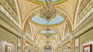 A grand hallway with a high ceiling, ornate chandeliers, and a patterned carpet. - Fairmont Copley Plaza, Boston (Boston)