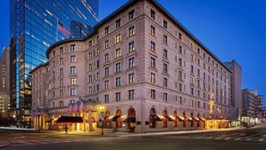 A historic building with a classic architectural style, featuring a symmetrical facade, multiple windows, and a prominent entrance with a covered walkway. - Fairmont Copley Plaza, Boston (Boston)