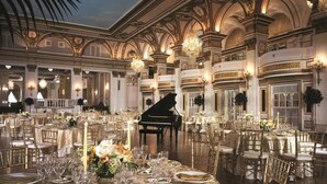 A grand ballroom with ornate architecture, chandeliers, and a grand piano. Tables are set with fine dining ware and flowers. - Fairmont Copley Plaza, Boston (Boston)