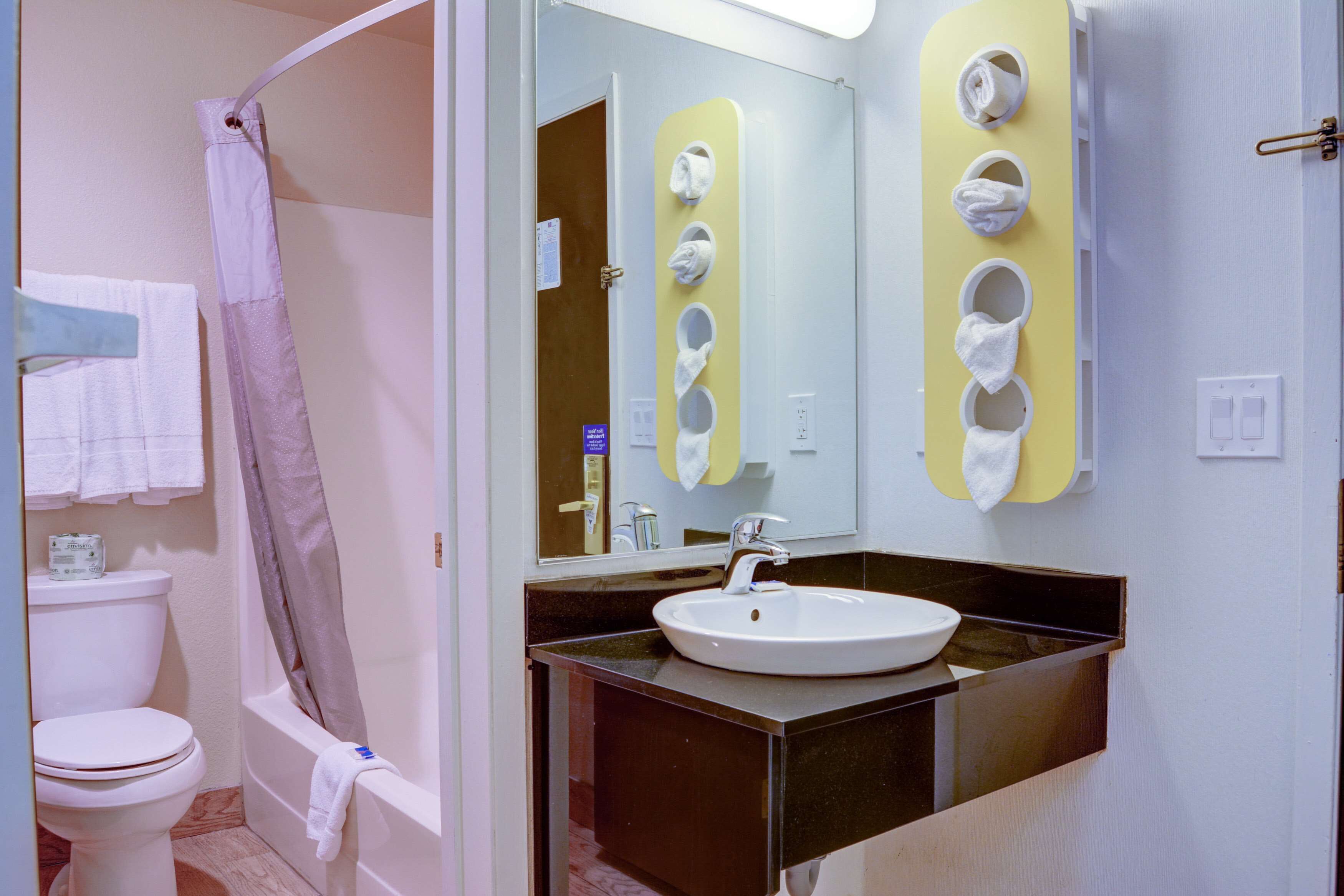 A bathroom with a toilet, sink, and shower.