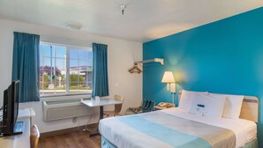 A hotel room with a bed, desk, chair, and a window with curtains. - Motel 6 The Dalles, OR (The Dalles)